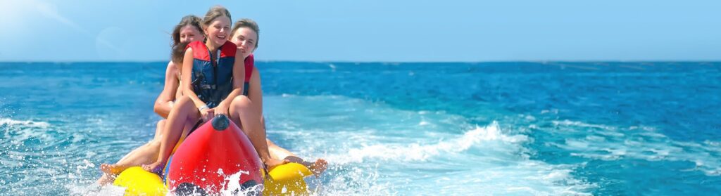 People ride on banana boat