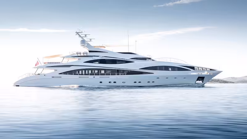 Luxury yacht cruising on calm blue water with clear sky backdrop, showcasing elegant design and spacious decks.