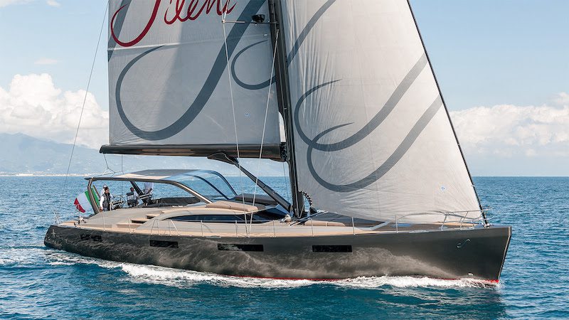 Luxury sailboat with sleek design cruising on open sea with clear skies and Italian flag displayed at the stern